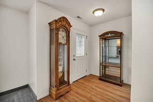 Foyer featuring baseboards and light wood-type flooring
