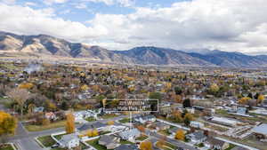 Aerial overview of property's location with a mountainous background and nearby suburban area