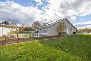 Rear view of house with stucco siding and roof mounted solar panels