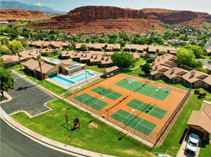 Aerial view of residential area featuring a pool and a mountain backdrop