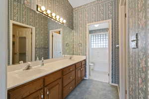 Master Bathroom with double vanity, beautifully decorated in desert colors and wallpapered walls