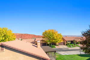 View of front of house featuring a chimney and a front lawn