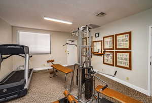 Workout room with a textured ceiling
