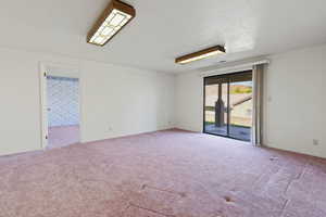 Lower Level family / Game room with walk-out covered patio & mtn views.