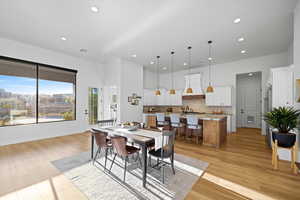 Dining space with light wood-style flooring and recessed lighting