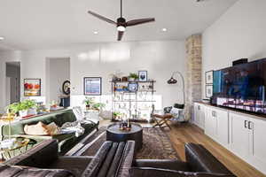 Living room featuring light wood-style flooring, ceiling fan, and recessed lighting