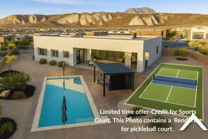 Back of property with stucco siding, a mountain view, a patio area, and an outdoor pool