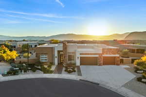 View of front of property with a mountain view, stucco siding, driveway, and an attached garage