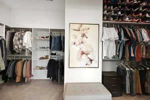 Spacious closet featuring light colored carpet
