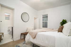 Carpeted bedroom featuring baseboards and ensuite bathroom