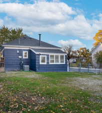 Rear view of house with a shingled roof