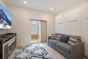 Living room with recessed lighting and light colored carpet