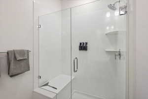 Full bathroom featuring a shower stall