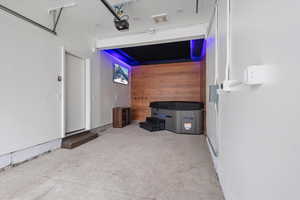 Garage featuring wood walls and a garage door opener