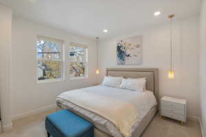 Carpeted bedroom with baseboards and recessed lighting