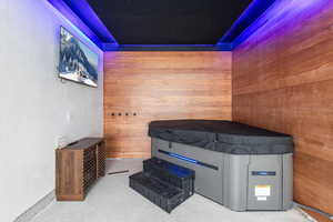 Relaxing sauna featuring a textured wall and wood walls