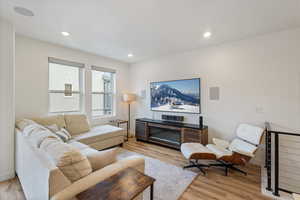Living area featuring light wood-type flooring and recessed lighting