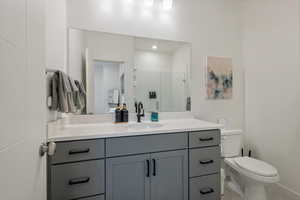 Bathroom with vanity, a stall shower, and light tile patterned flooring