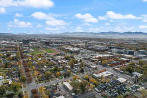 Aerial view of property's location with a mountain backdrop and nearby urban area