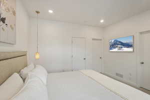 Bedroom with recessed lighting and baseboards