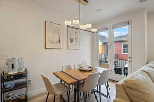 Dining space featuring light wood-type flooring and baseboards
