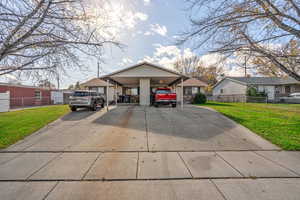 Bungalow-style home featuring driveway and a carport