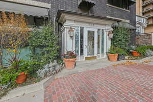 Property entrance featuring brick siding and french doors