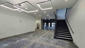 Staircase featuring baseboards and french doors