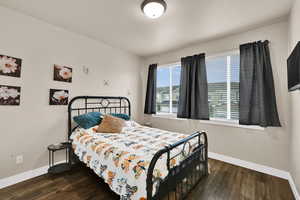 Bedroom with dark wood-type flooring