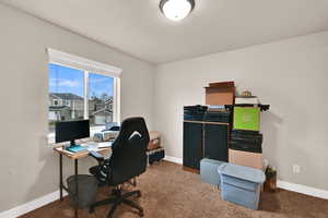 Office area featuring baseboards and carpet