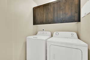 Laundry area with cabinet space and washer and dryer