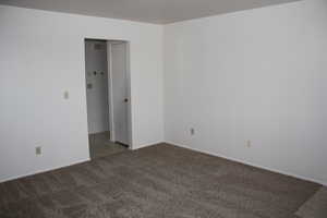 Carpeted spare room with baseboards
