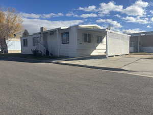 Manufactured / mobile home with a carport and concrete driveway