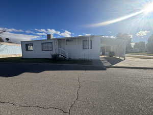 Manufactured / mobile home with a carport and driveway