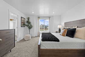 Bedroom featuring light colored carpet and baseboards