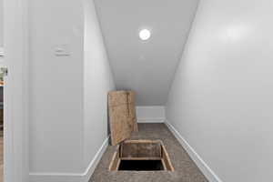 Stairs featuring carpet and vaulted ceiling