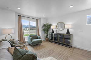 Sitting room featuring light wood-style floors, recessed lighting, and a mountain view
