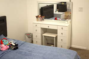Bedroom featuring baseboards and carpet flooring