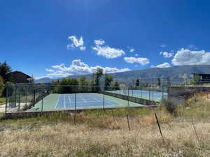 View of tennis court featuring a mountain view