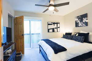 Bedroom featuring access to outside, light carpet, a ceiling fan, and a textured ceiling