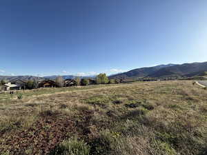 View of mountain backdrop with rural landscape