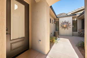 View of exterior entry with stucco siding