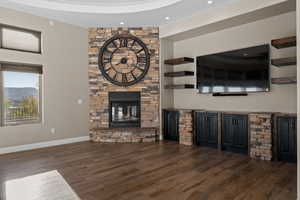 Unfurnished living room with a fireplace, dark wood finished floors, and recessed lighting