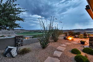 View of yard featuring an outdoor fire pit, a patio area, and a mountain view