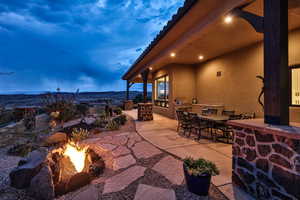 View of patio / terrace featuring an outdoor fire pit, a mountain view, outdoor dining area, and a grill