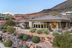 Back of property featuring a patio, stucco siding, a tiled roof, and a mountain view