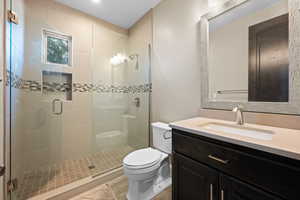 Full bathroom with vanity and a stall shower