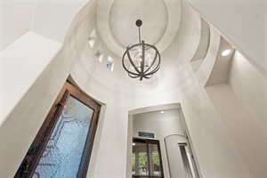 Detailed view of a chandelier and recessed lighting