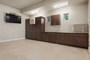 Spare room with baseboards and dark speckled floor