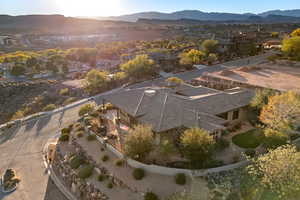 Aerial view of property's location with mountains and nearby suburban area